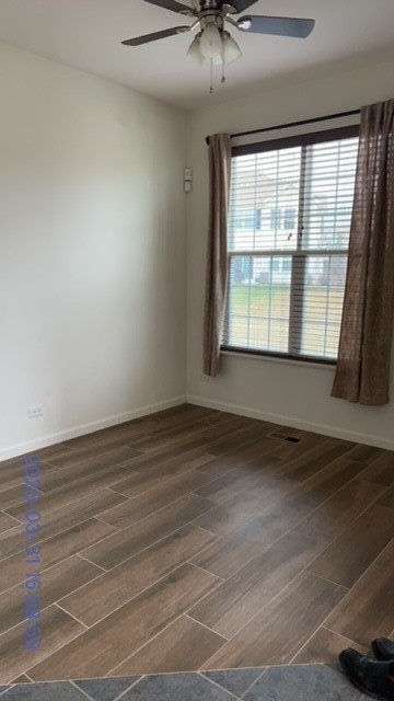 10070 Cummings Street, Unit 3401 Huntley, IL 60142 - Photo 9 of 27 an empty room with wooden floor and windows