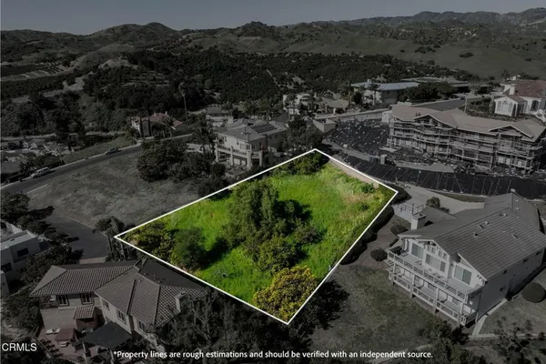 an aerial view of a residential houses with outdoor space