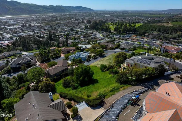 an aerial view of residential house with green space