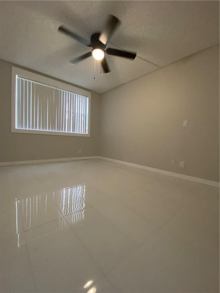 8801 Wiles Road, Unit 207 Coral Springs, FL 33067 - Photo 12 of 31 an empty room with windows