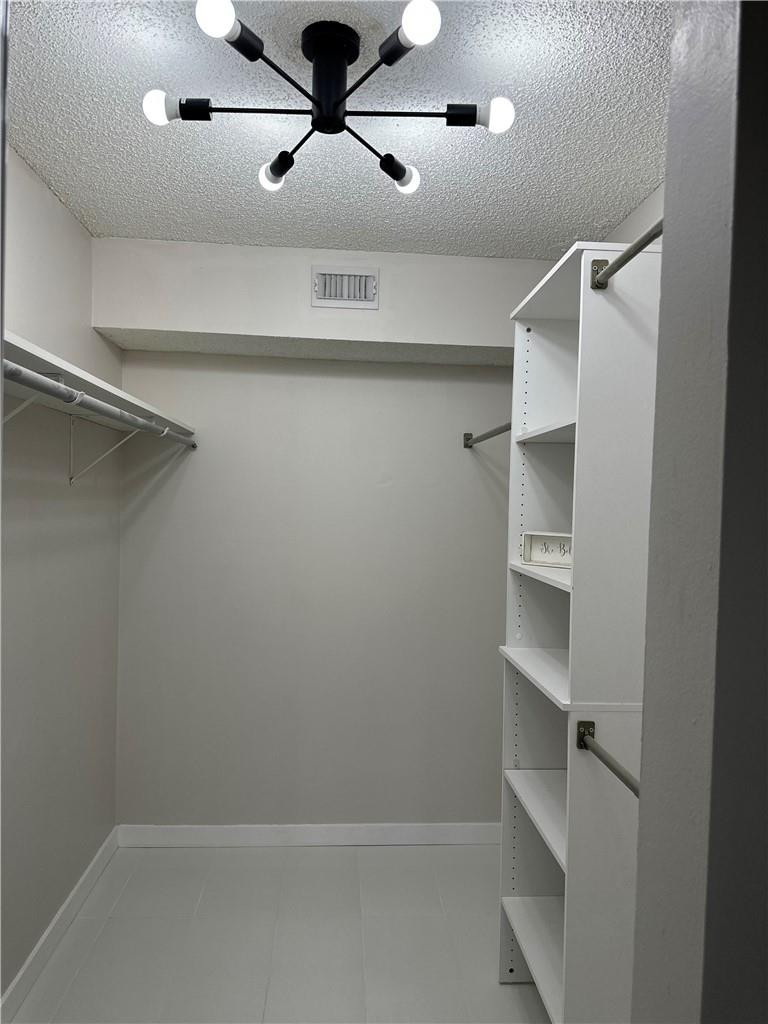 8801 Wiles Road, Unit 207 Coral Springs, FL 33067 - Photo 13 of 31 a view of an empty walk in closet