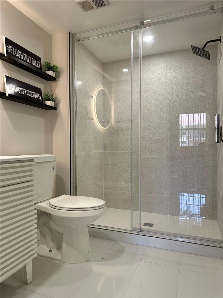 8801 Wiles Road, Unit 207 Coral Springs, FL 33067 - Photo 15 of 31 a bathroom with a toilet and a shower
