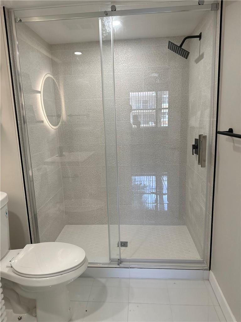 8801 Wiles Road, Unit 207 Coral Springs, FL 33067 - Photo 16 of 31 a bathroom with a toilet and a shower