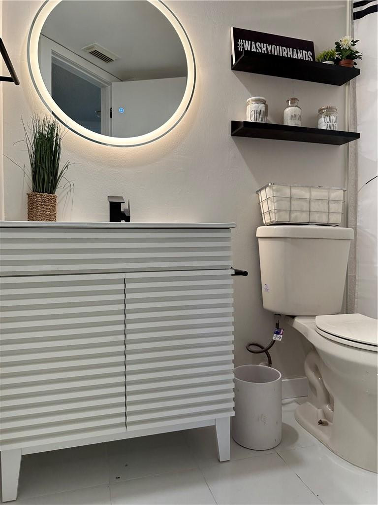 8801 Wiles Road, Unit 207 Coral Springs, FL 33067 - Photo 25 of 31 a bathroom with a toilet and a sink