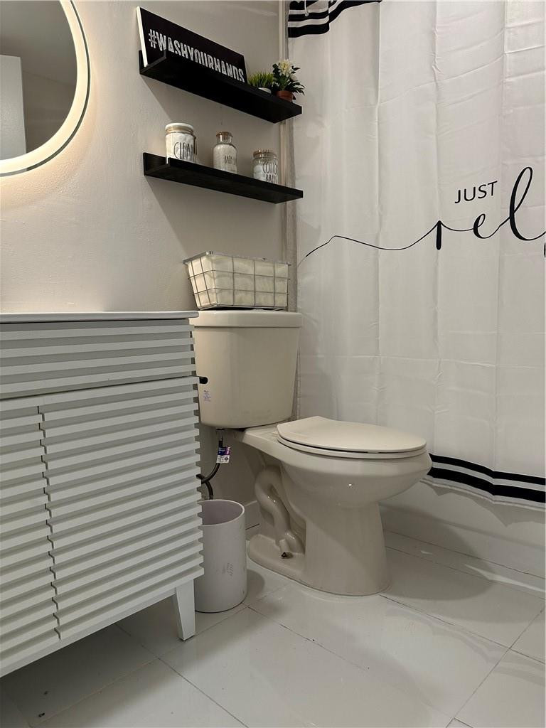 8801 Wiles Road, Unit 207 Coral Springs, FL 33067 - Photo 26 of 31 a white toilet sitting next to a bathroom sink