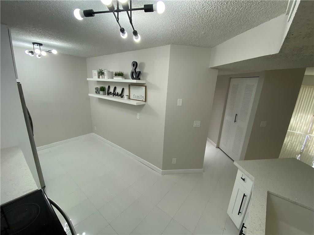 8801 Wiles Road, Unit 207 Coral Springs, FL 33067 - Photo 6 of 31 a view of a hallway with elevator