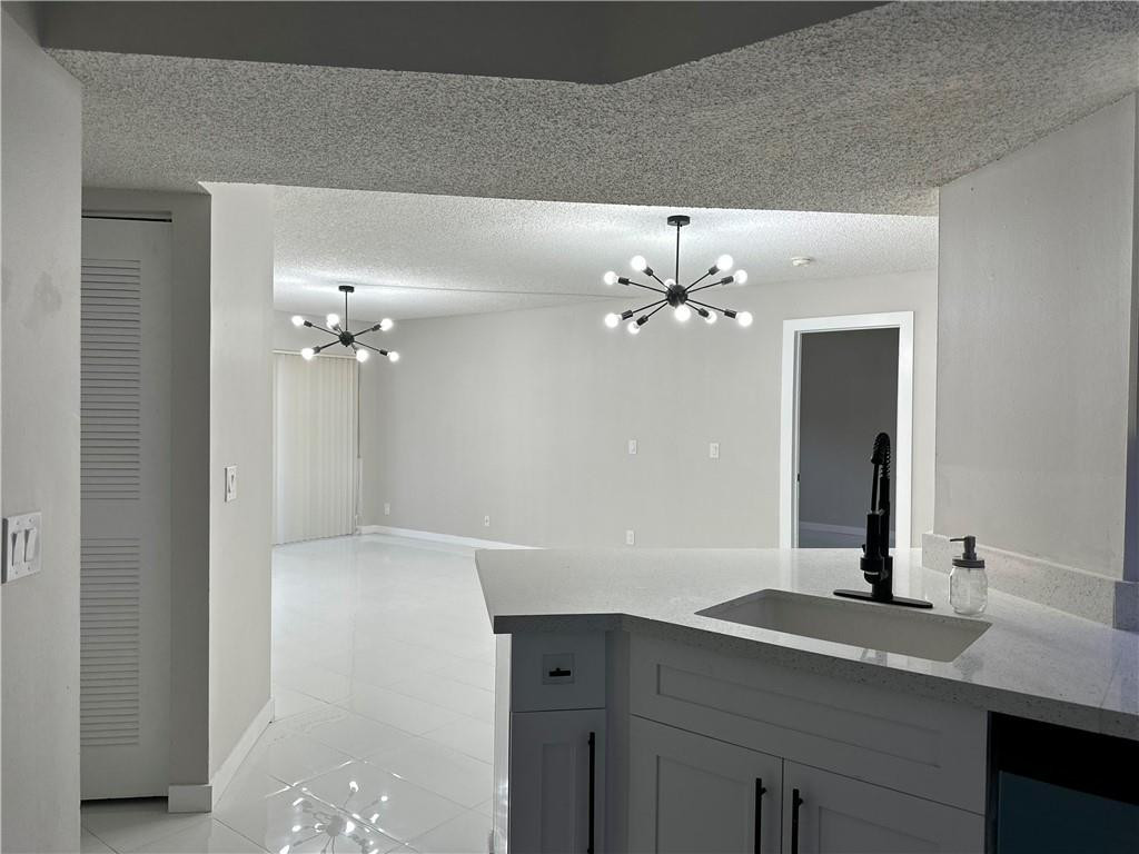 8801 Wiles Road, Unit 207 Coral Springs, FL 33067 - Photo 8 of 31 a bathroom with a sink vanity and a mirror