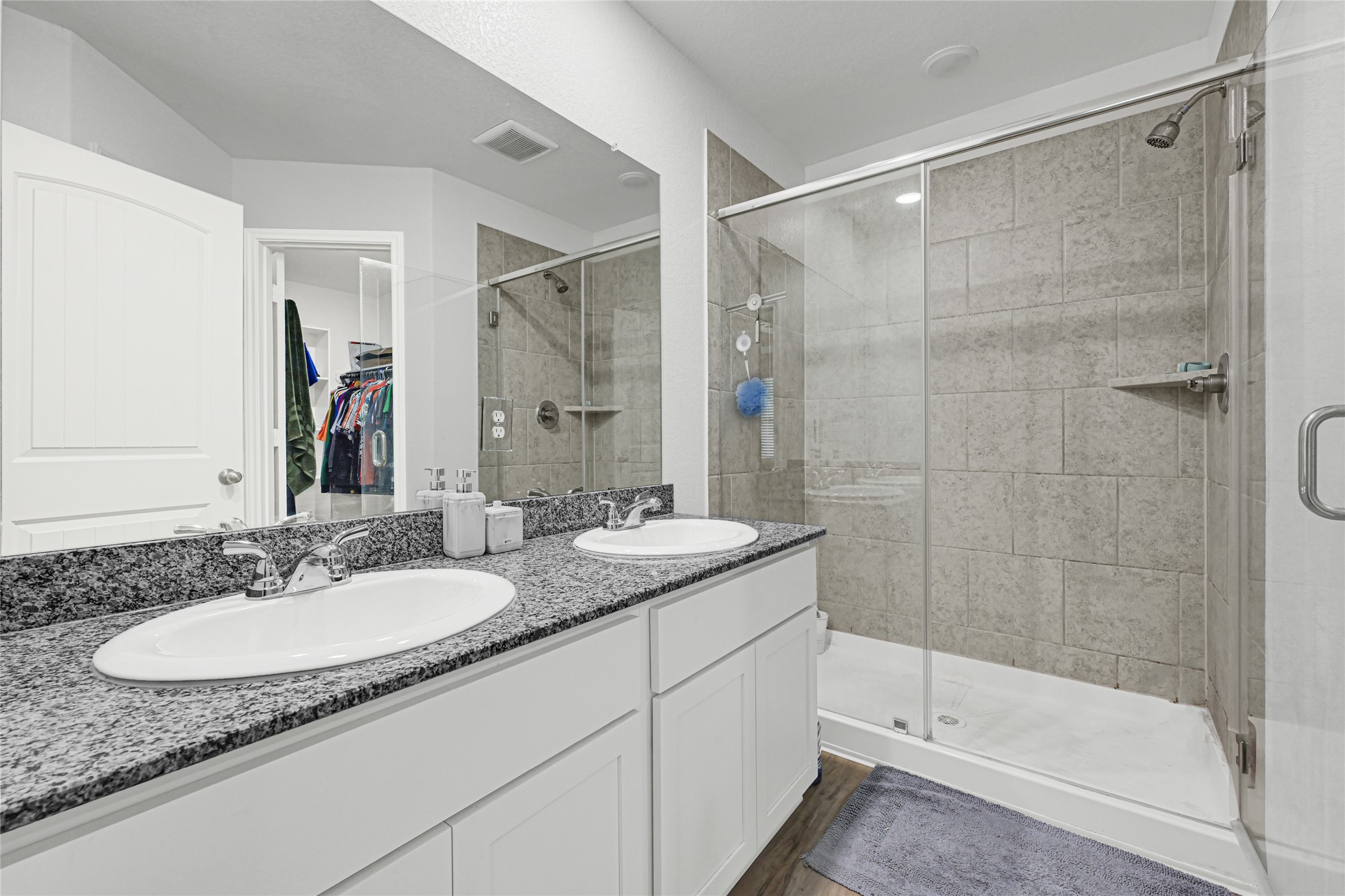 5325 Basquiat Drive Houston, TX 77048 - Photo 15 of 21 a bathroom with a granite countertop sink a mirror and a shower