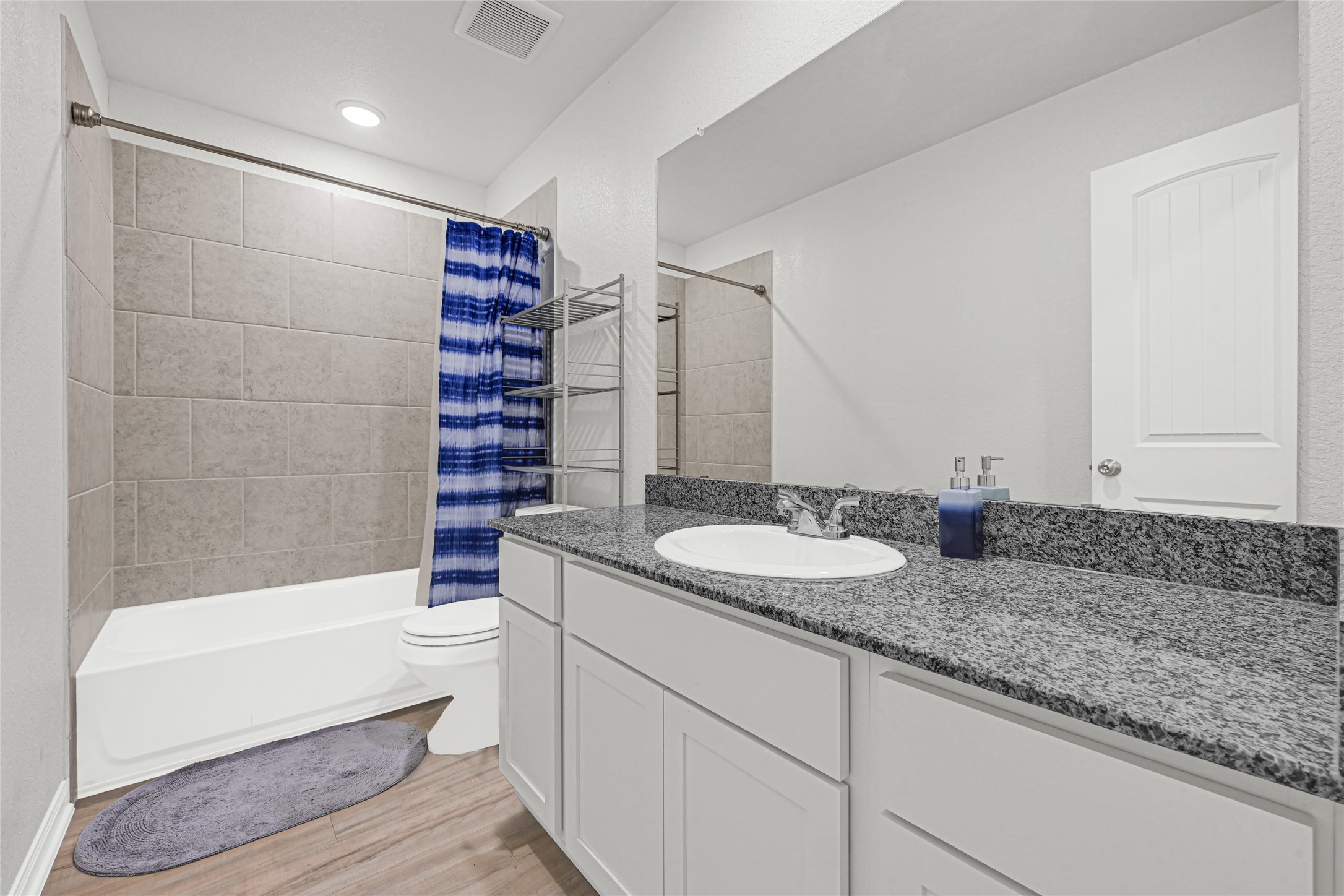 5325 Basquiat Drive Houston, TX 77048 - Photo 18 of 21 a bathroom with a granite countertop sink and a mirror