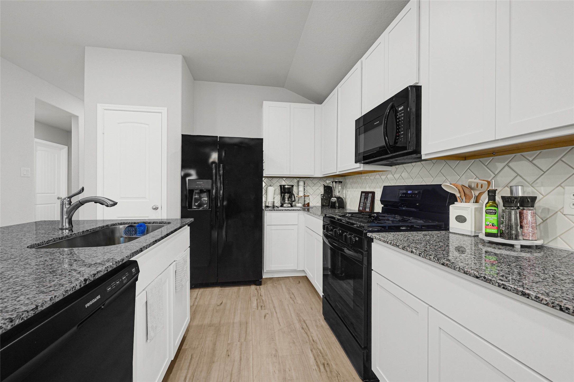 5325 Basquiat Drive Houston, TX 77048 - Photo 7 of 21 a kitchen with stainless steel appliances granite countertop a refrigerator a stove top oven a sink and dishwasher