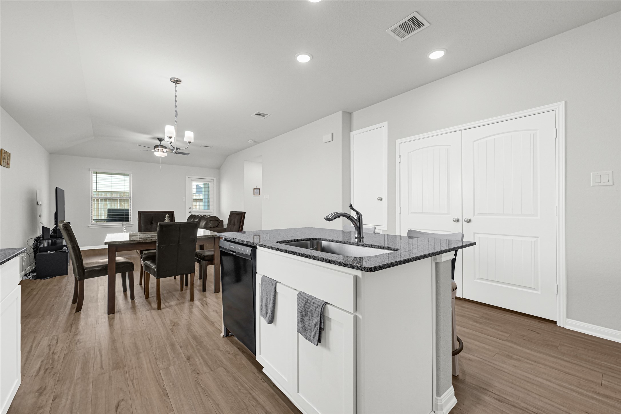 5325 Basquiat Drive Houston, TX 77048 - Photo 8 of 21 a kitchen that has a lot of cabinets a sink stainless steel appliances and wooden floor