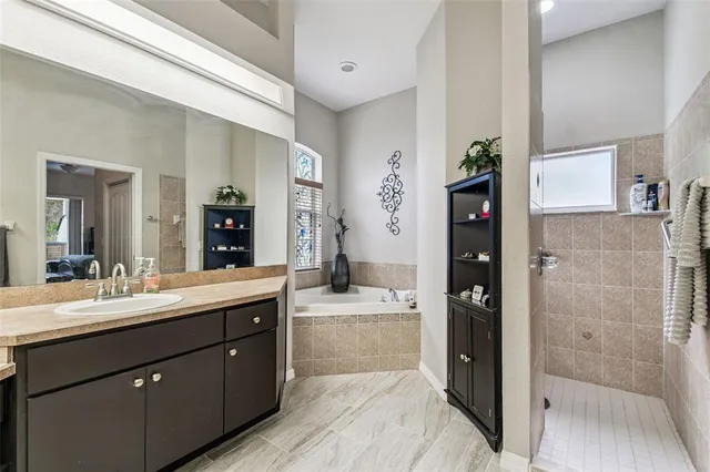 a en suite bathroom with a sink a mirror and a shower