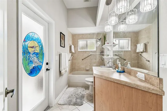 a bathroom with a granite countertop sink a bathtub and a shower