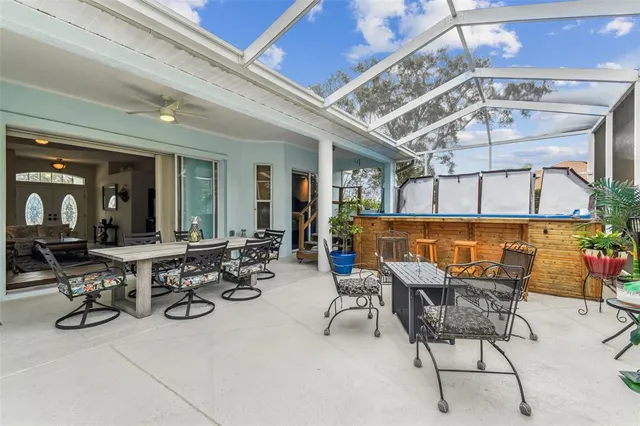 a view of a patio with table and chairs with wooden floor and plants