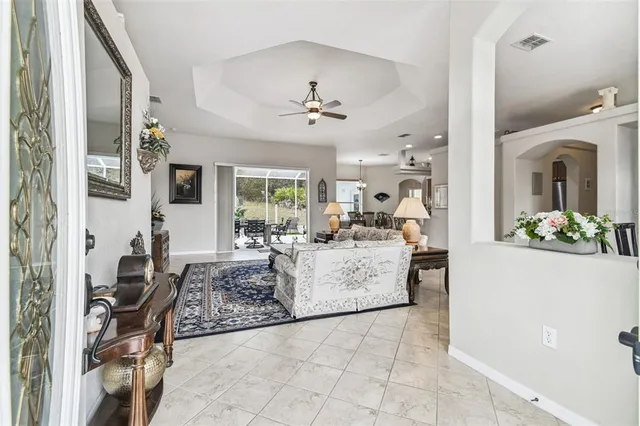a living room with furniture a chandelier and a window