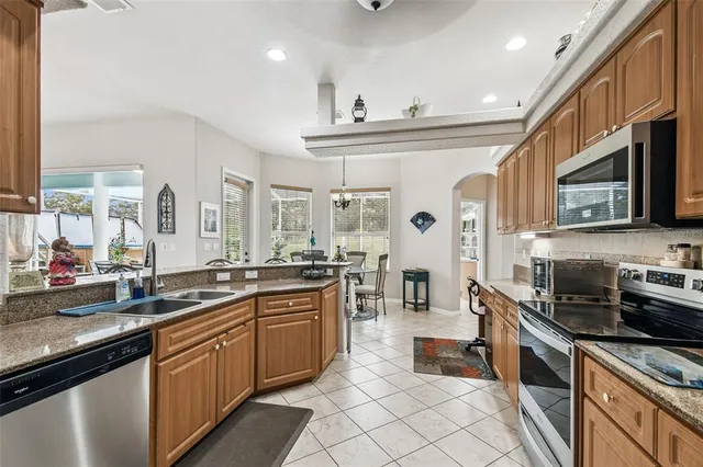 a kitchen with stainless steel appliances granite countertop a sink and cabinets