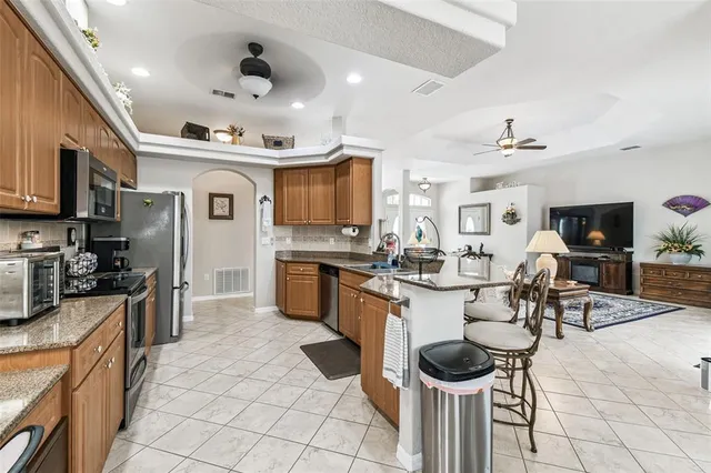 a kitchen with stainless steel appliances granite countertop a sink and cabinets