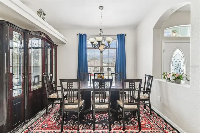 a view of a dining room with furniture wooden floor and a chandelier
