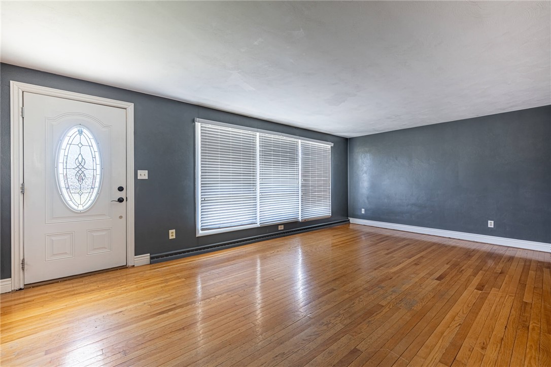 5235 West Ridgewood Road Springfield, OH 45503 - Photo 2 of 32 Enter into a welcoming living space featuring bright hardwood flooring and natural light.