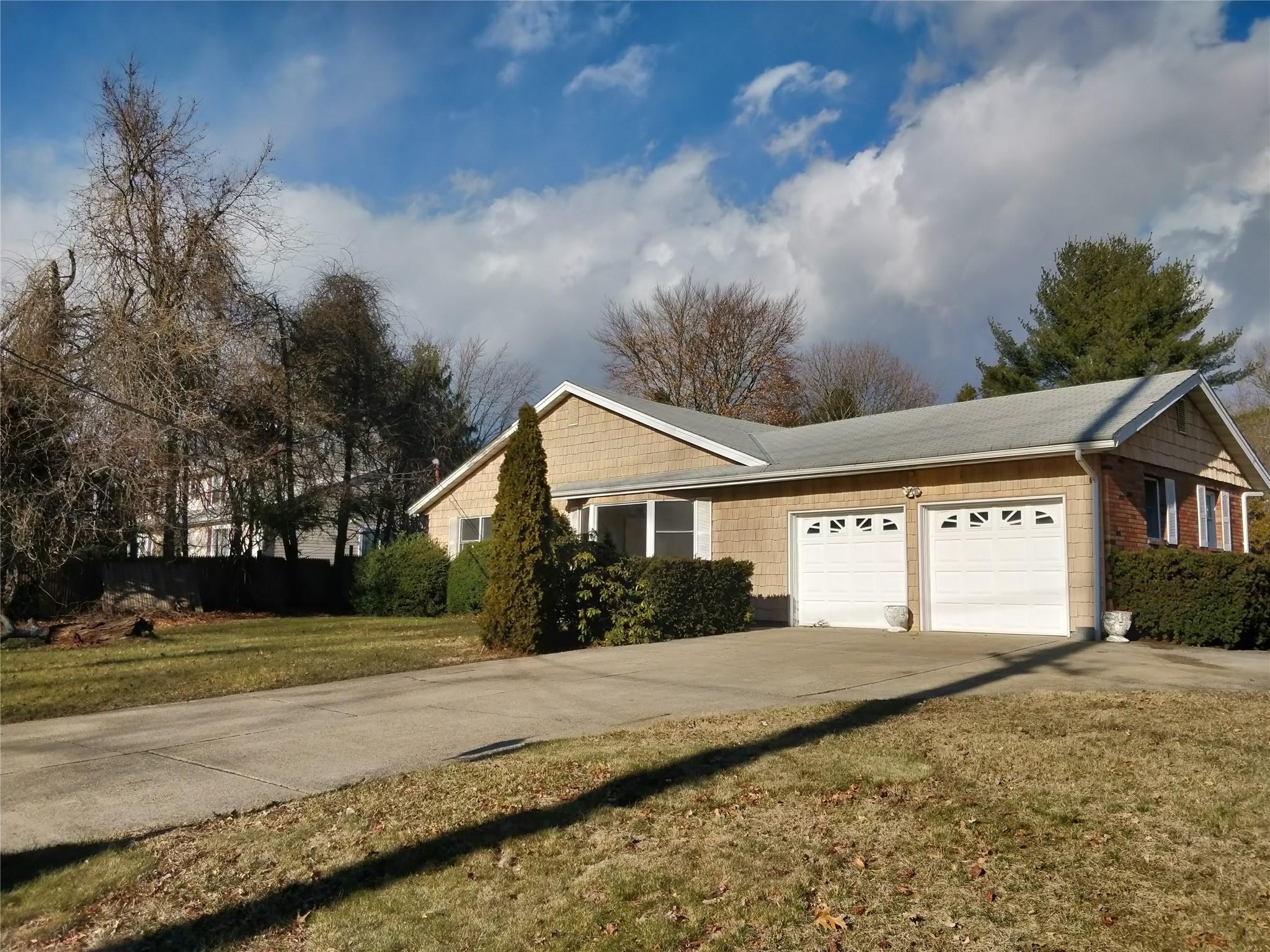 71 Lake Road Huntington, NY 11740 - Photo 1 of 1 View of property exterior with a garage and a yard