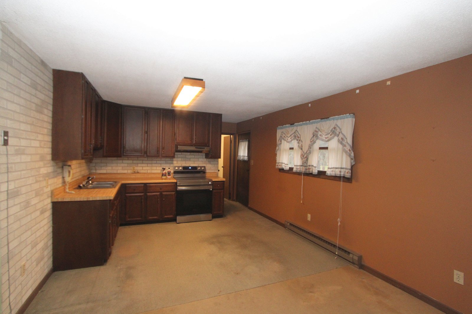 8105 Lawrence Road Harvard, IL 60033 - Photo 5 of 14 a kitchen with stainless steel appliances granite countertop a sink stove and cabinets