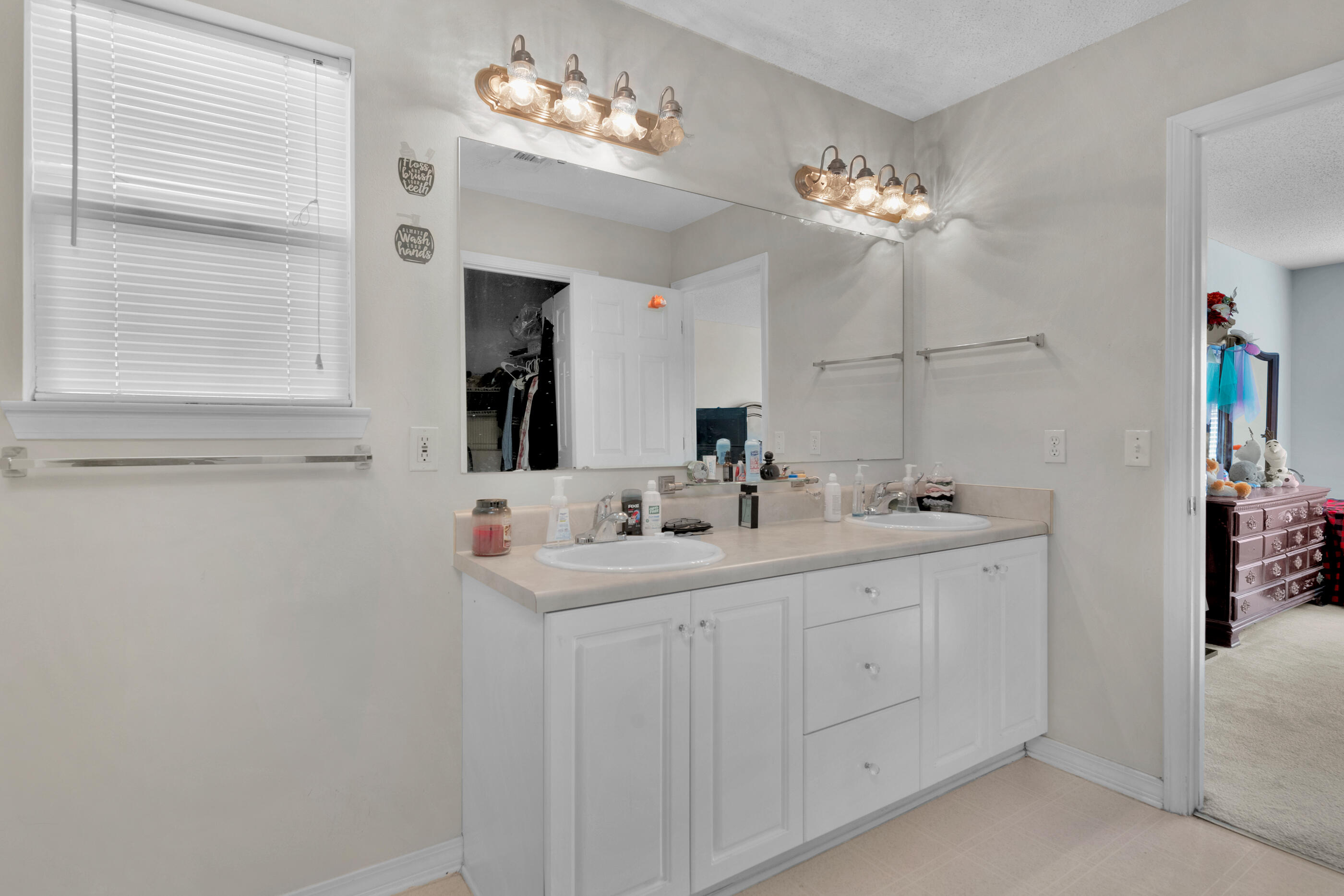 220 Riverchase Boulevard Crestview, FL 32536 - Photo 16 of 24 a bathroom with a double vanity sink and a mirror
