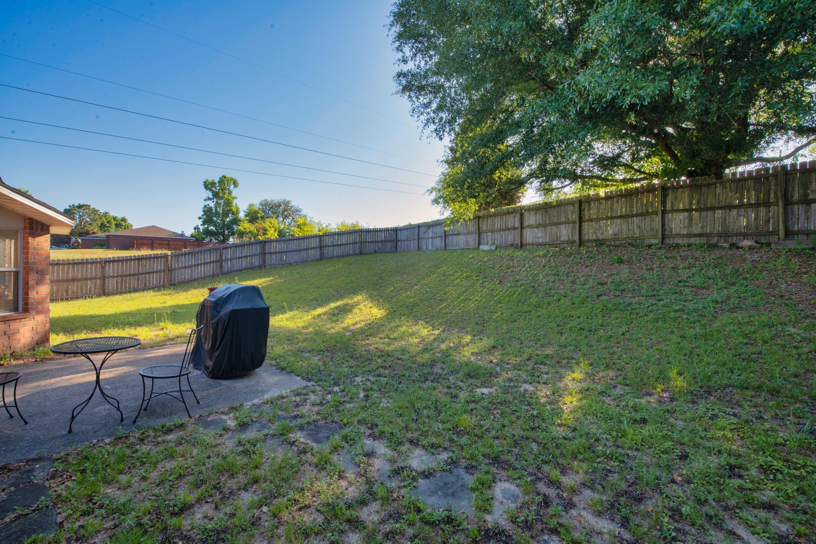 220 Riverchase Boulevard Crestview, FL 32536 - Photo 20 of 24 a view of a backyard with sitting area