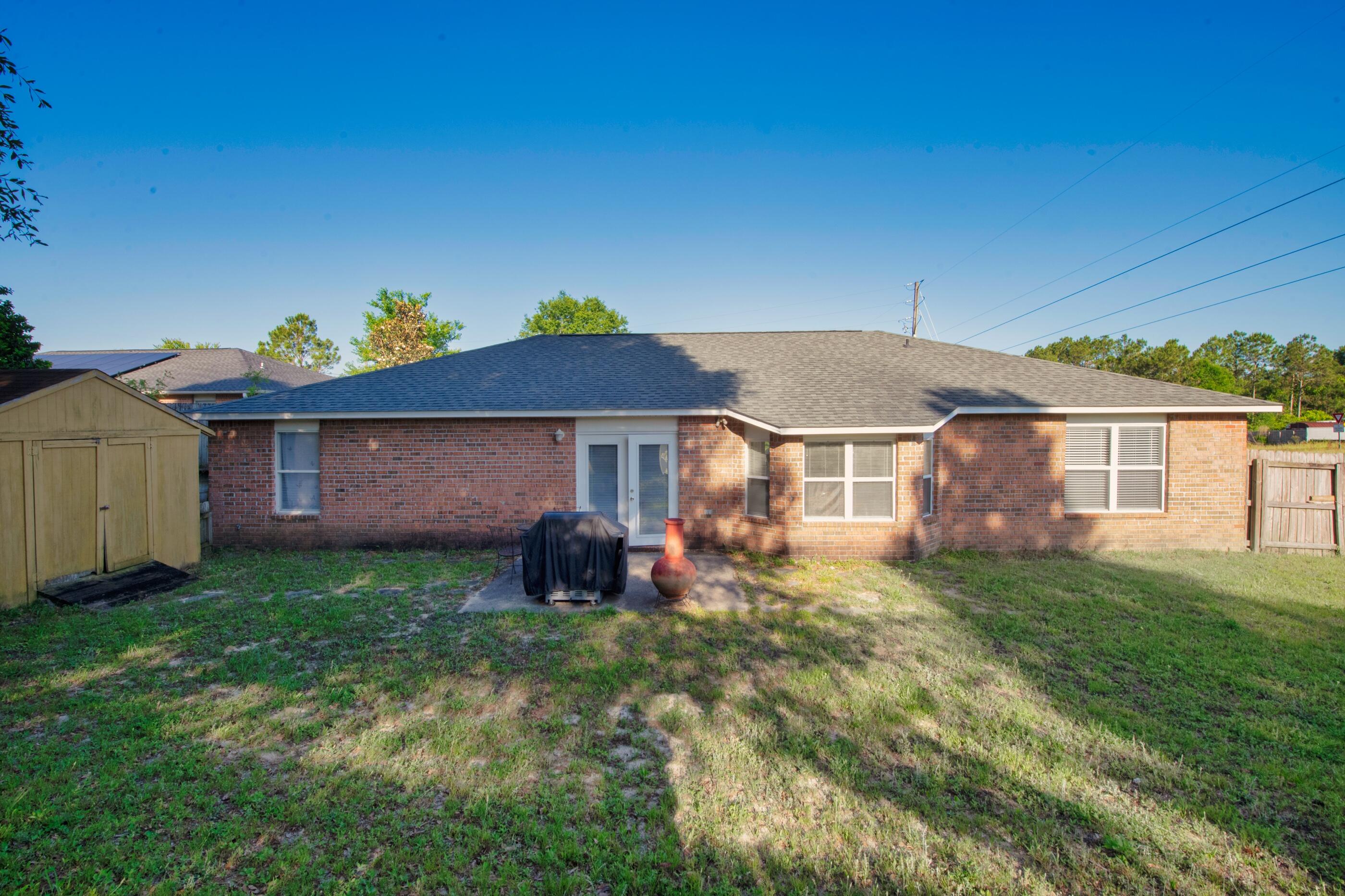 220 Riverchase Boulevard Crestview, FL 32536 - Photo 22 of 24 a view of a house with a yard