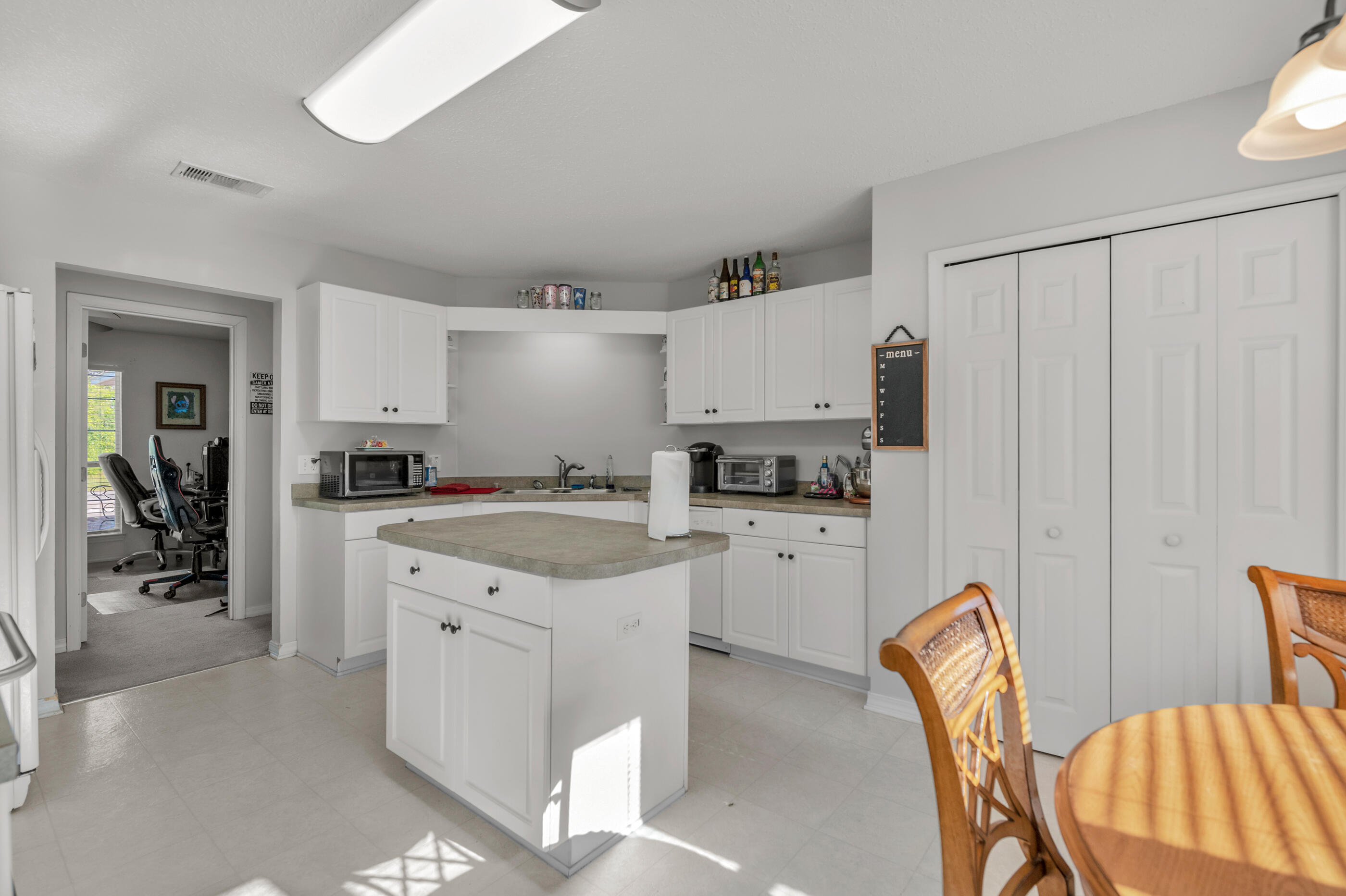 220 Riverchase Boulevard Crestview, FL 32536 - Photo 4 of 24 a kitchen with white cabinets and refrigerator