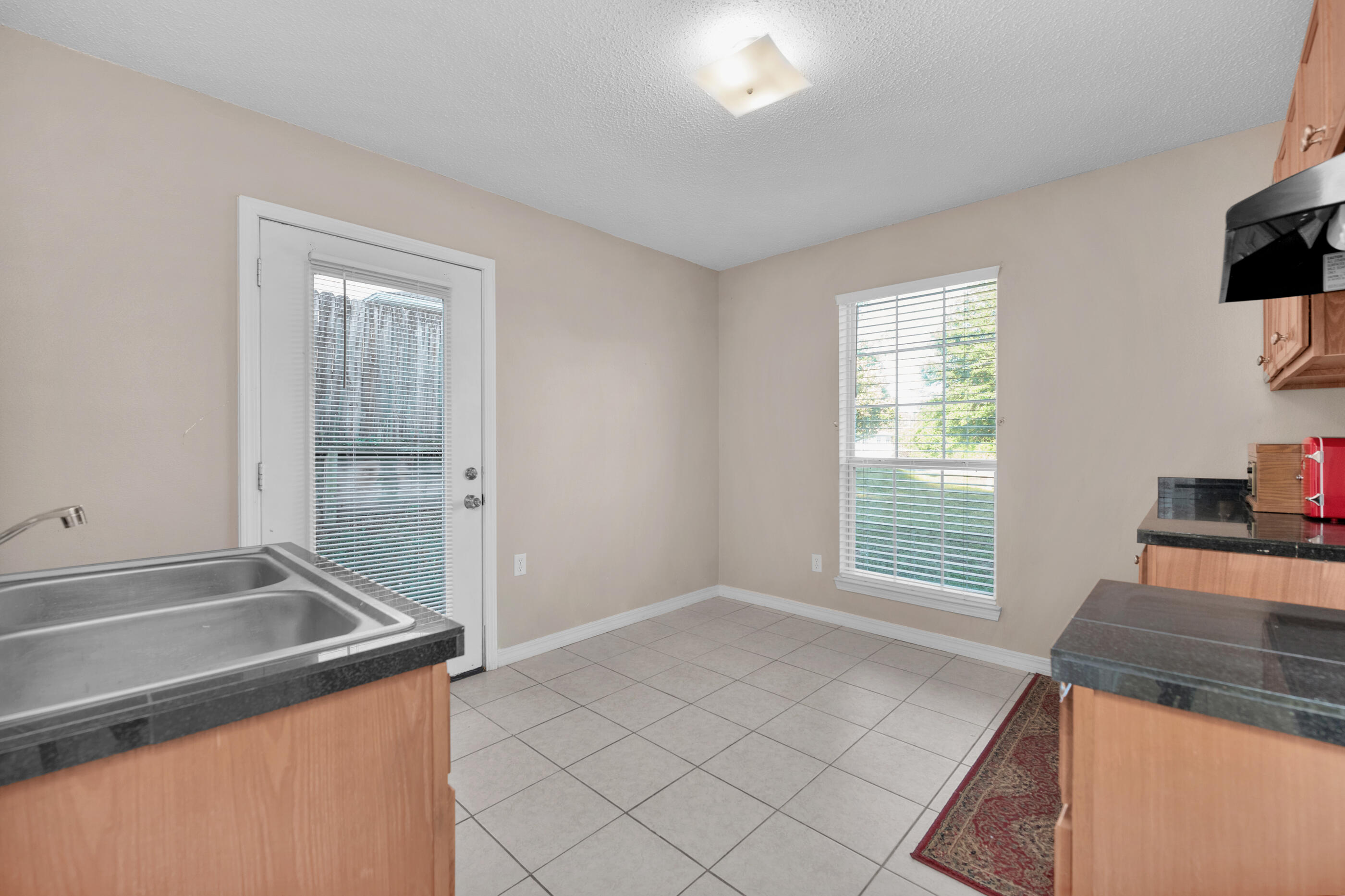 220 Riverchase Boulevard Crestview, FL 32536 - Photo 9 of 24 a view of a kitchen that shows a sink stove and cabinets