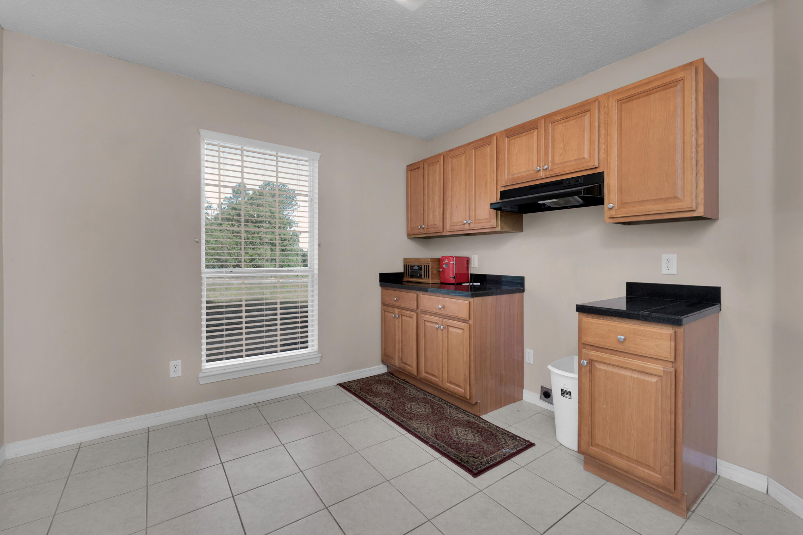 220 Riverchase Boulevard Crestview, FL 32536 - Photo 10 of 24 a kitchen with white cabinets and appliances