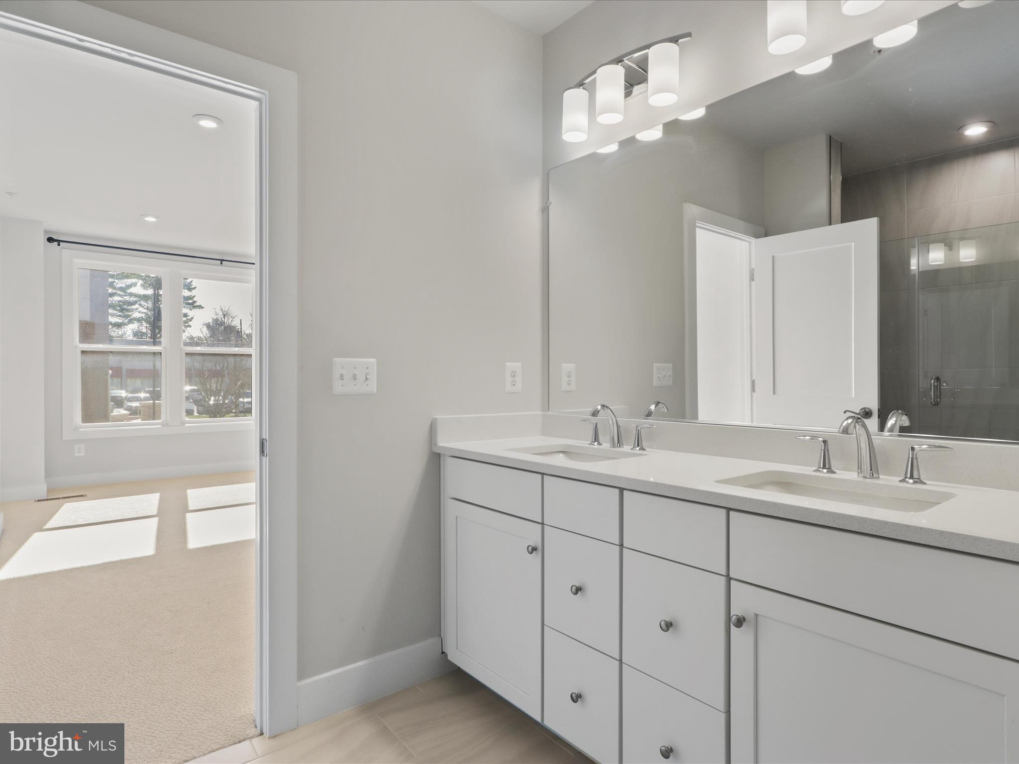 1696 Bandit Loop Reston, VA 20190 - Photo 14 of 38 a bathroom with double sink and a mirror