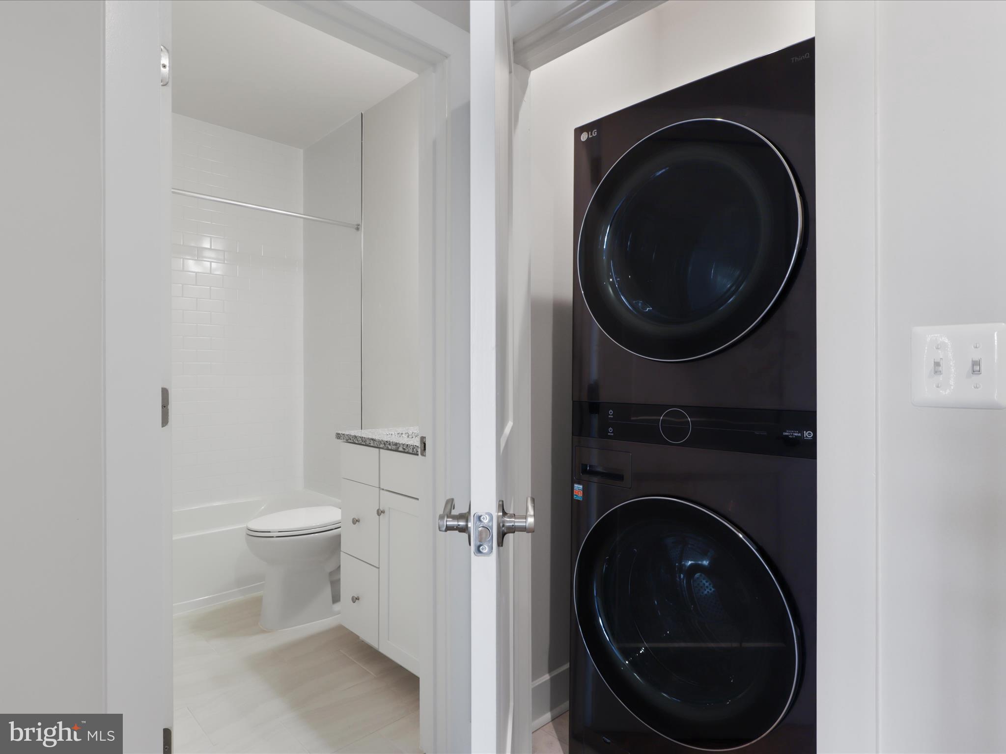 1696 Bandit Loop Reston, VA 20190 - Photo 24 of 38 a view of a bathroom with a washer and dryer