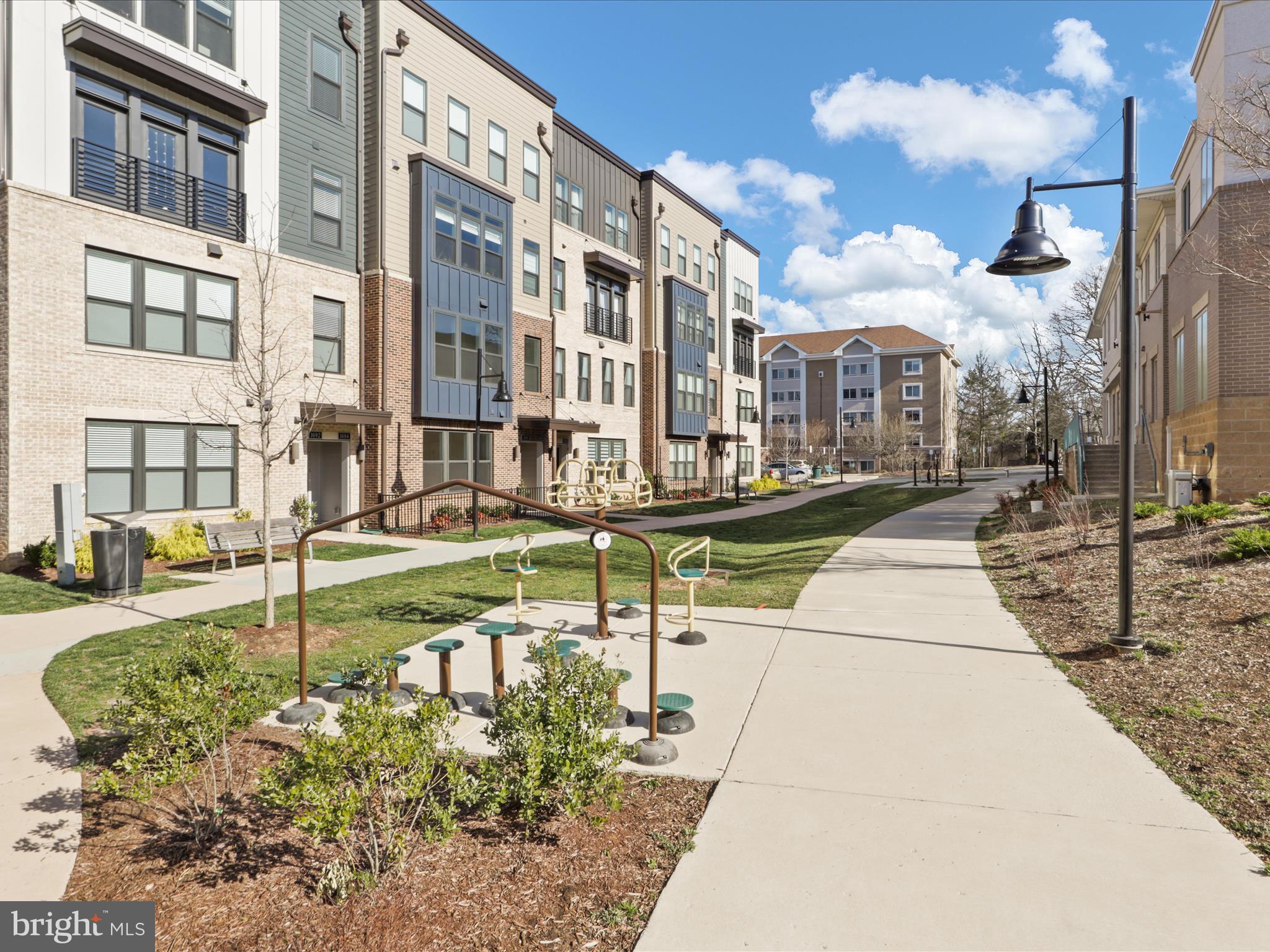 1696 Bandit Loop Reston, VA 20190 - Photo 30 of 38 a building exterior with water fountain and trees