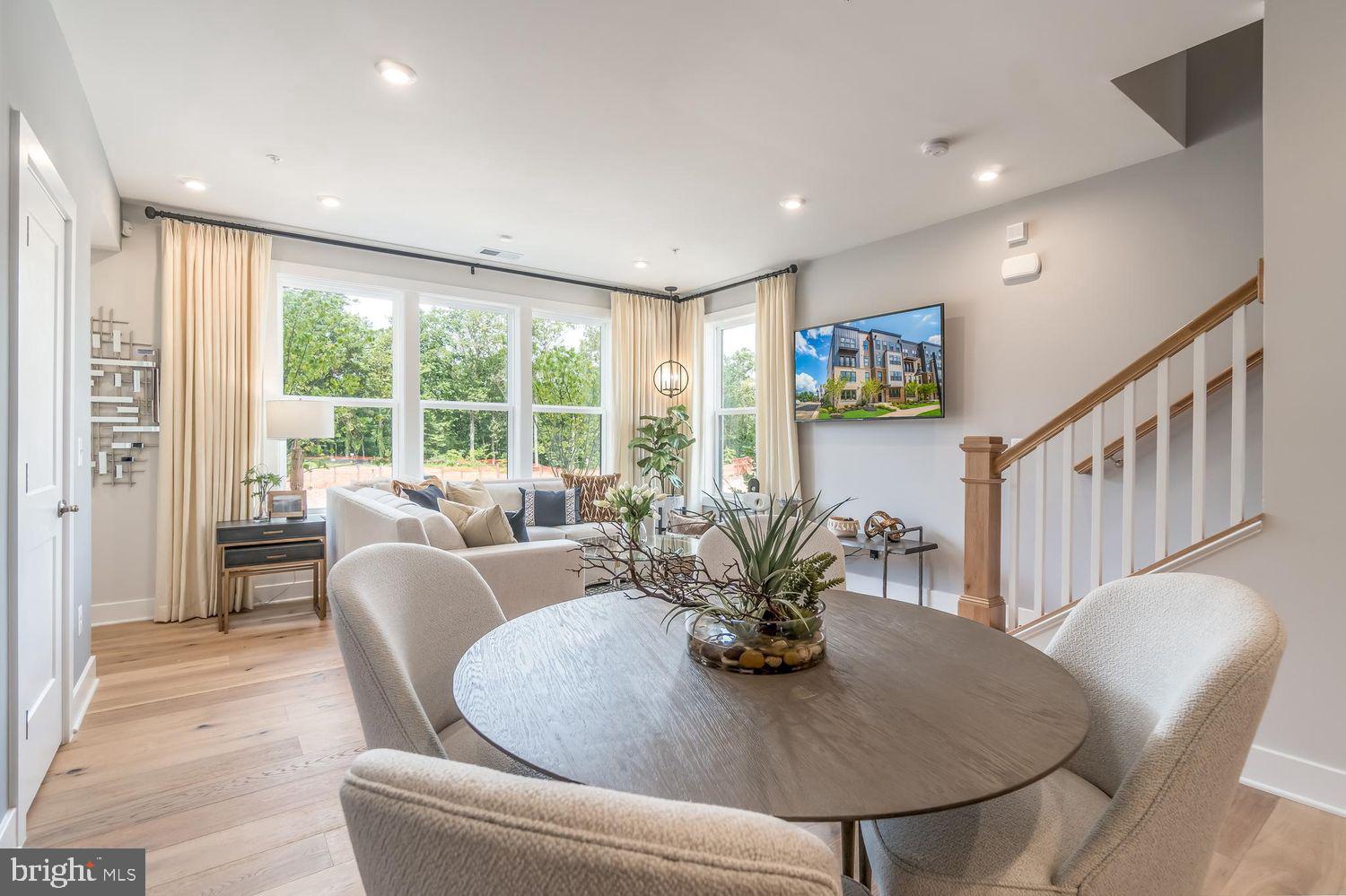 1696 Bandit Loop Reston, VA 20190 - Photo 5 of 38 a dining room with furniture a large window and a potted plant