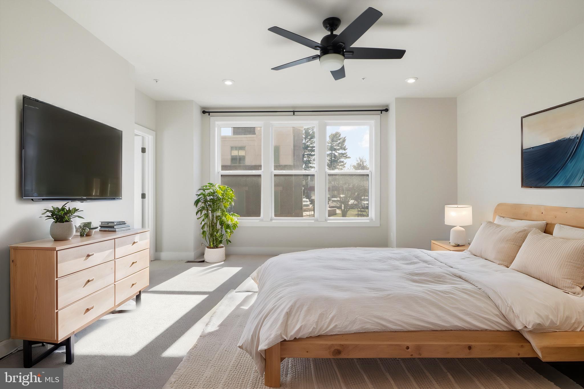 1696 Bandit Loop Reston, VA 20190 - Photo 10 of 38 a bedroom with a large bed and a flat screen tv