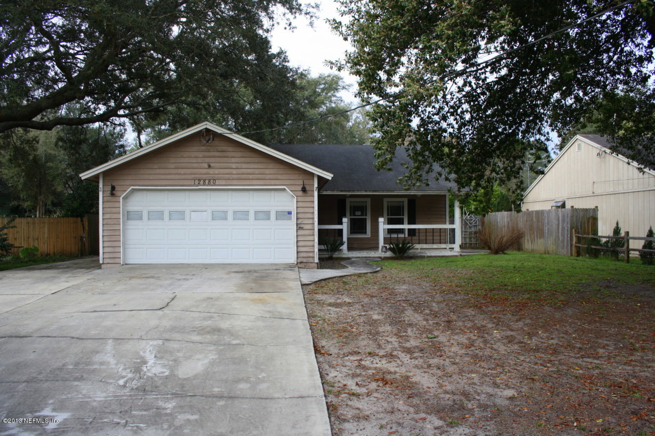 12880 Beaubien Road Jacksonville, FL 32258 - Photo 1 of 20 a view of a house with a yard and large tree