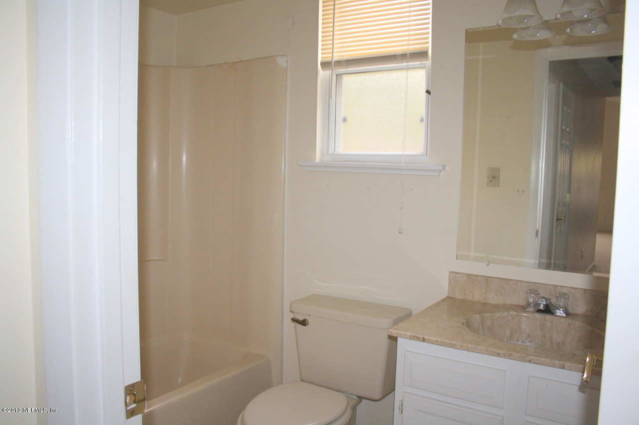 12880 Beaubien Road Jacksonville, FL 32258 - Photo 12 of 20 a bathroom with a granite countertop sink toilet and shower