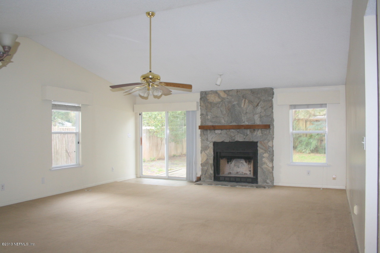 12880 Beaubien Road Jacksonville, FL 32258 - Photo 2 of 20 an empty room with windows and fireplace