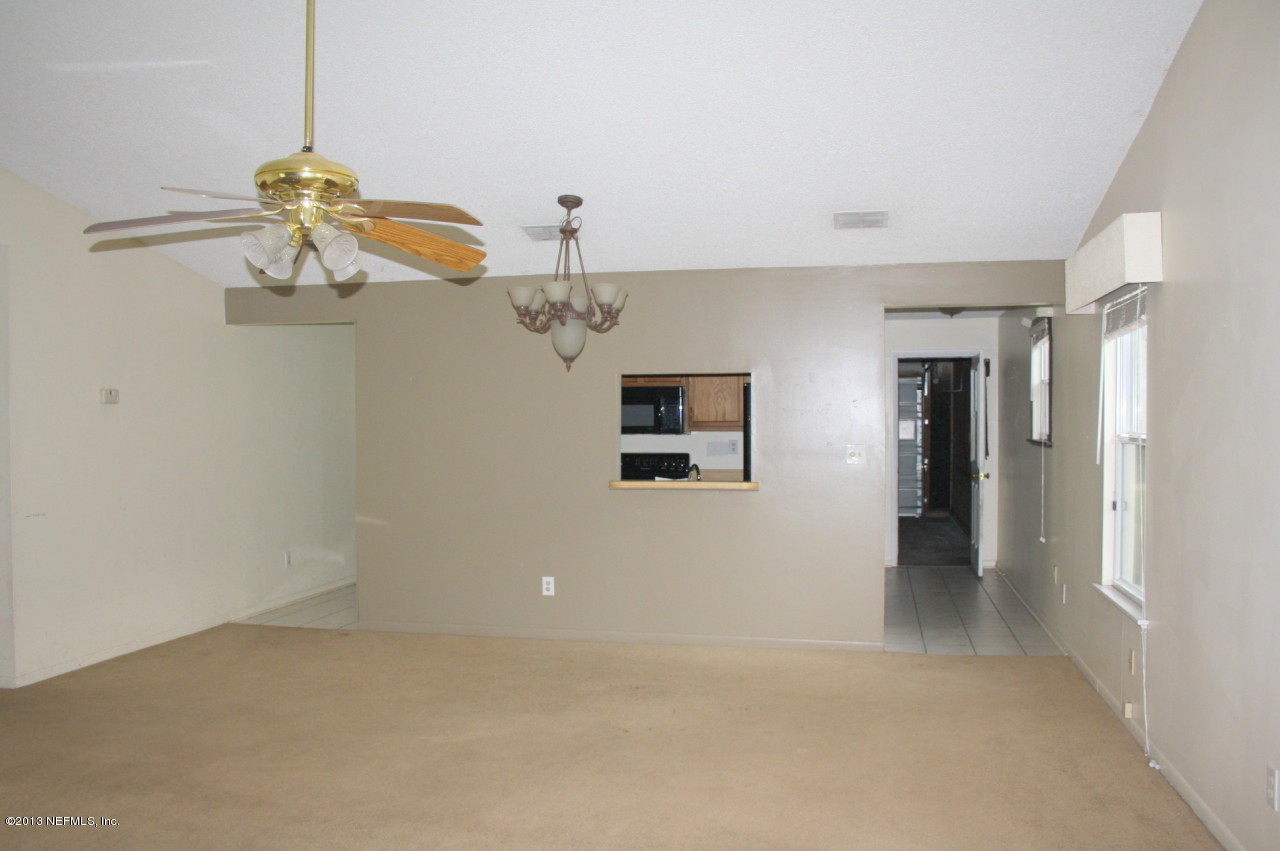 12880 Beaubien Road Jacksonville, FL 32258 - Photo 3 of 20 a view of a chandelier fan and refrigerator in a room