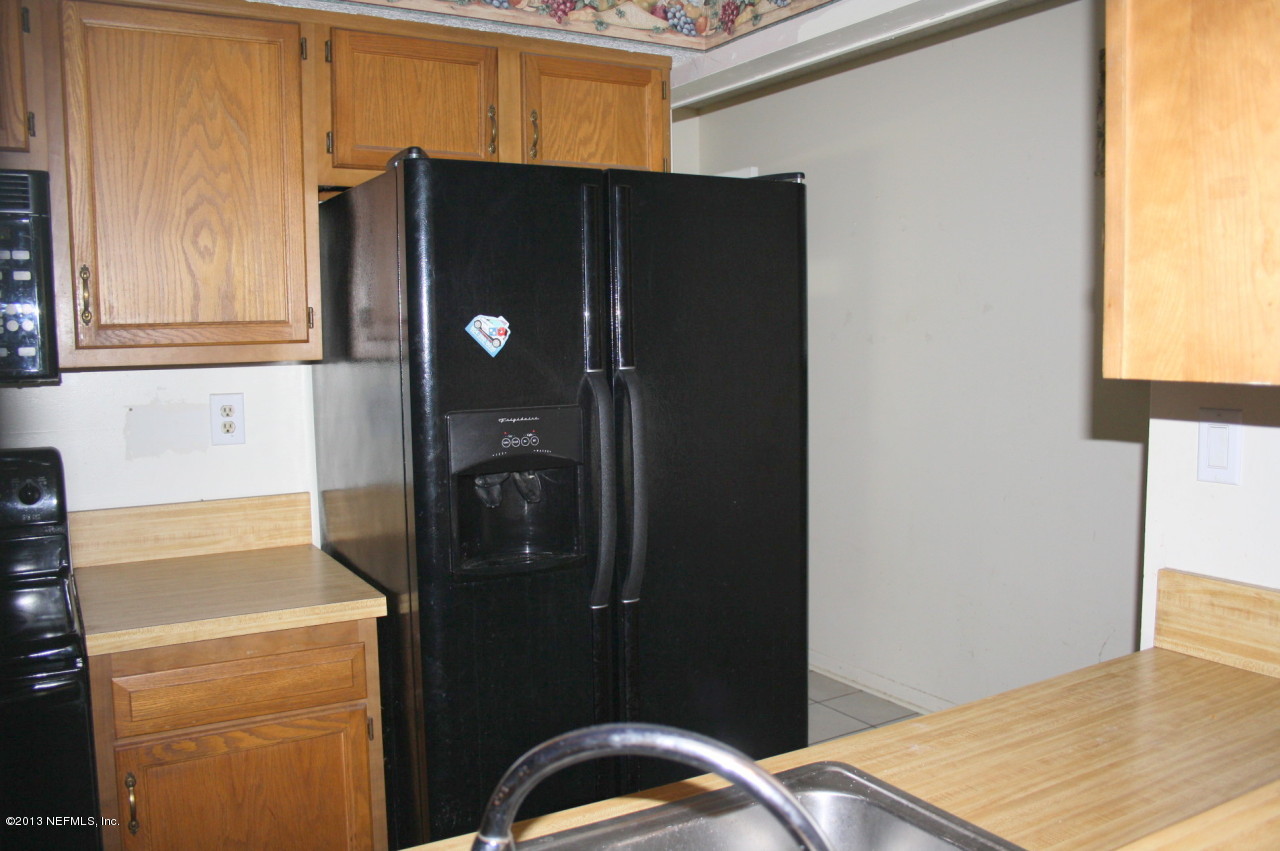 12880 Beaubien Road Jacksonville, FL 32258 - Photo 7 of 20 a kitchen with a refrigerator and cabinets