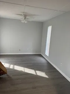 a view of a room with wooden floor and white walls