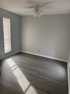 311 Elm Street Portland, TX 78374 - Photo 12 of 26 an empty room with wooden floor chandelier fan and windows