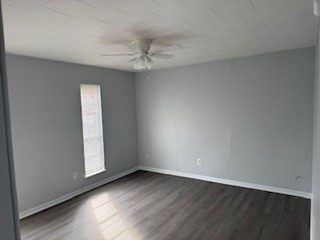 311 Elm Street Portland, TX 78374 - Photo 15 of 26 an empty room with wooden floor fan and windows
