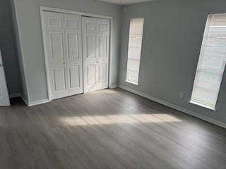 311 Elm Street Portland, TX 78374 - Photo 17 of 26 an empty room with wooden floor and windows