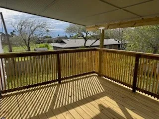 a view of a balcony with wooden floor