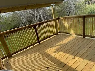 a view of balcony with wooden floor