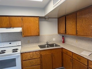 311 Elm Street Portland, TX 78374 - Photo 6 of 26 a kitchen with stainless steel appliances a sink dishwasher and cabinets with wooden floor