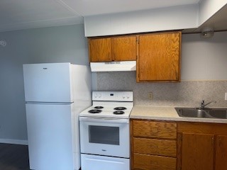311 Elm Street Portland, TX 78374 - Photo 8 of 26 a kitchen with a refrigerator and a sink