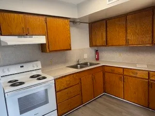a kitchen with a sink stove and cabinets